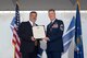 Retired Brigadier Gen. Gregory Otey presents Chief Master Sgt. Brandon Broughman, 347th Rescue Group superintendent, with a retirement certificate during Broughman’s retirement ceremony, Sept. 1, 2017, at Moody Air Force Base, Ga. Broughman concluded his 30-year career as a loadmaster. During his tenure, he dedicated service to more than 5 variants of C-130’s in air mobility and tactical air drop support. (U.S. Air Force photo by Senior Airman Greg Nash)