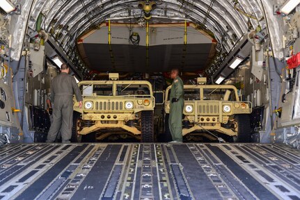 Texas Air National Guard airmen load a Lockheed C-130 Hercules on the flightline