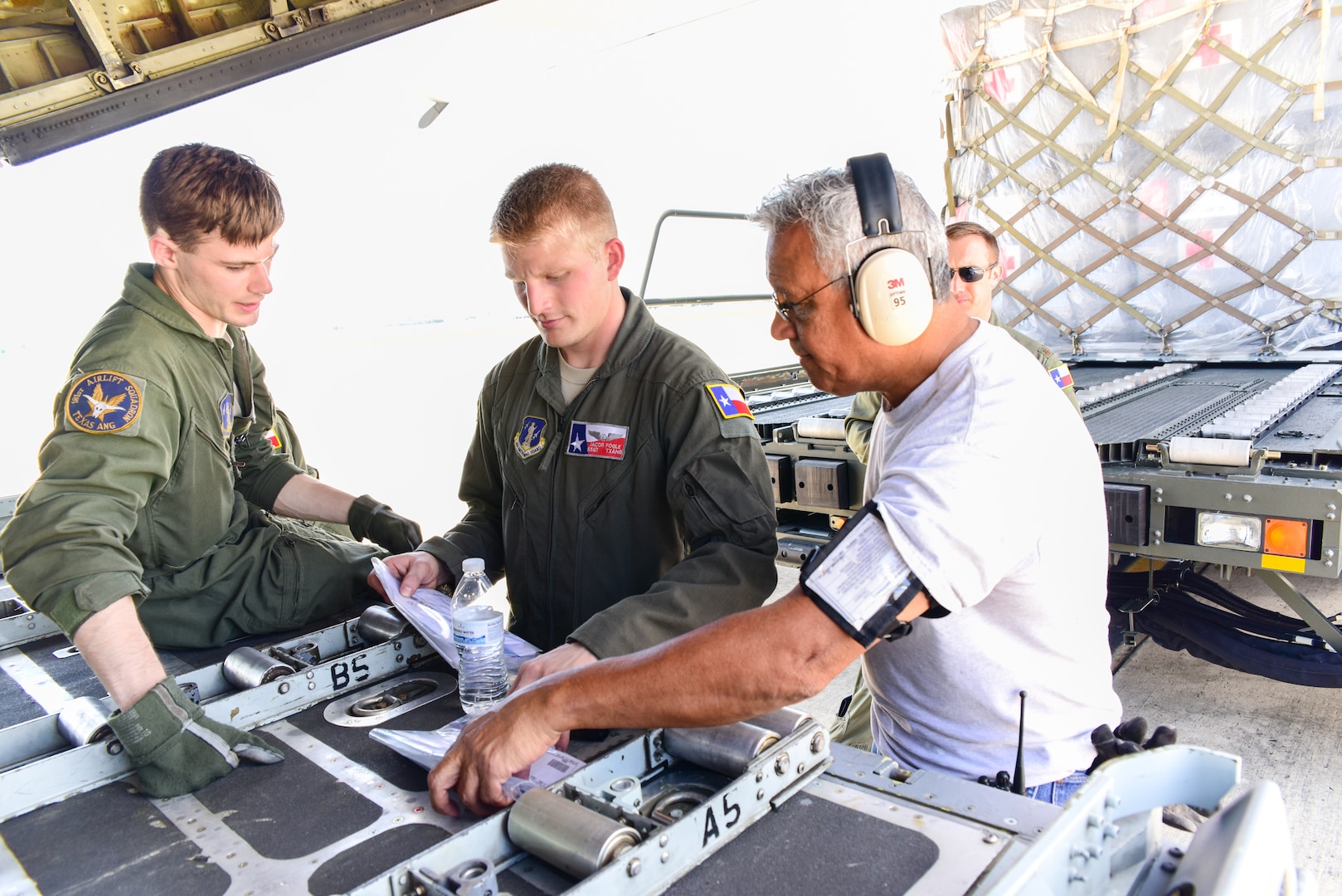 Texas Air National Guard airmen load a Lockheed C-130 Hercules on the flightline