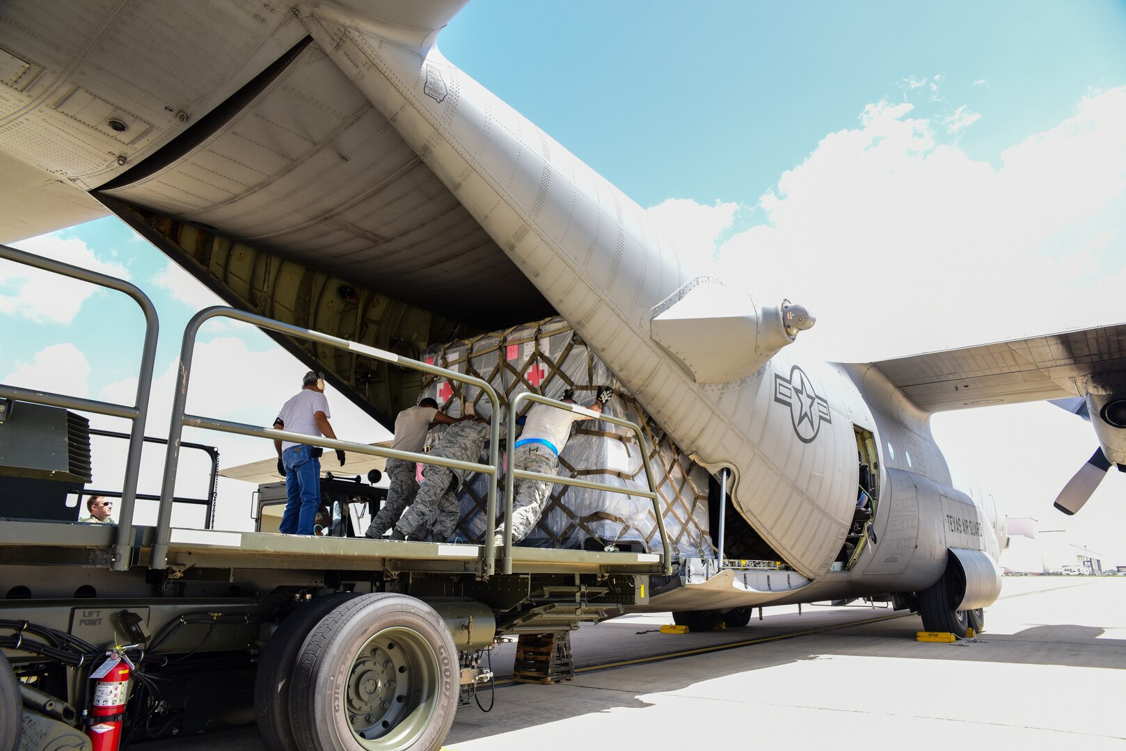 Texas Air National Guard airmen load a Lockheed C-130 Hercules on the flightline