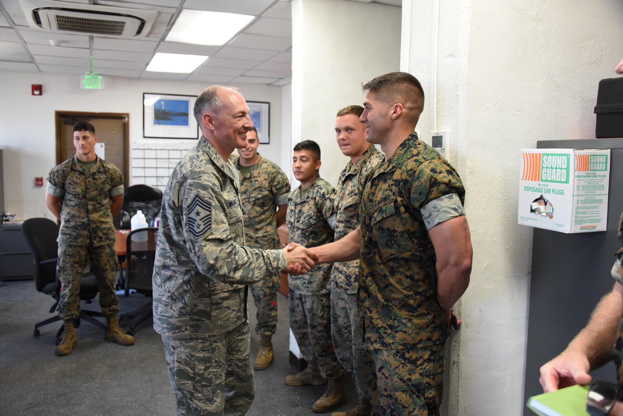 Command Chief Master Sgt. Larry Williams (left), USAF Expeditionary Center command chief, greets U.S. Marines with the 3rd Transportation Support Battalion, while visiting Kadena Air Base, Japan, Aug. 24, 2017. While visiting with Airmen at the 733rd Air Mobility Squadron, Williams along with Maj. Gen. Christopher Bence, USAF EC commander, met with some of their joint mission partners. (U.S. Air Force photo by Tech. Sgt. Jamie Powell)