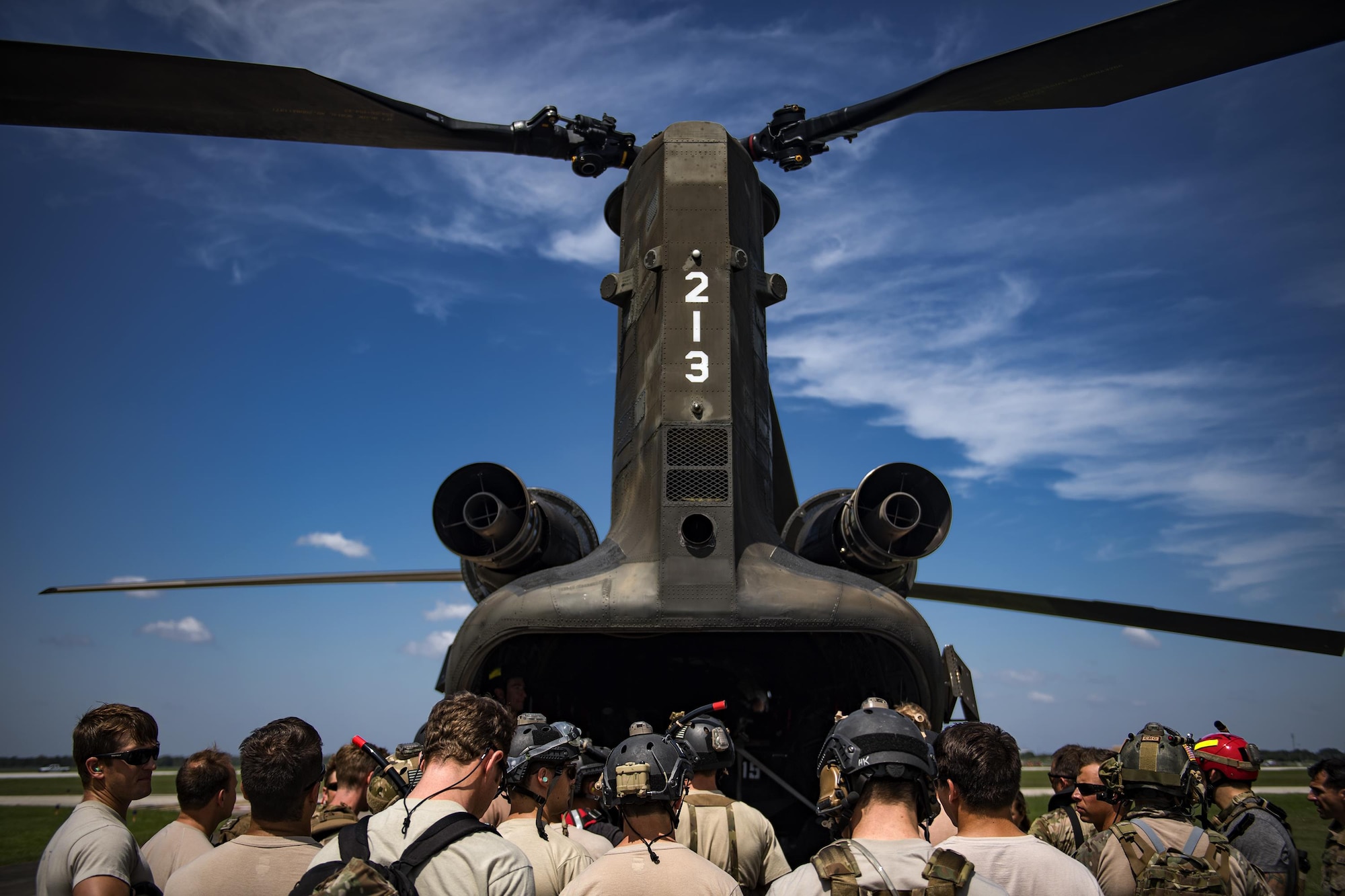 Pararescuemen from the 48th and 58th Rescue Squadrons gather around a CH-47 Chinook prior to setting up boat rescue operations, Aug. 30, 2017, at Easterwood Airport, College Park, Texas.