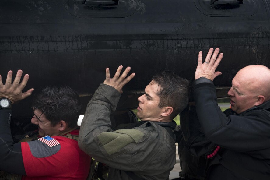 Pararescuemen from the 58th Rescue Squadron lift a rescue boat into a transport vehicle, Aug. 30, 2017, at the Orange County Convention and Expo Center in Orange, Texas.