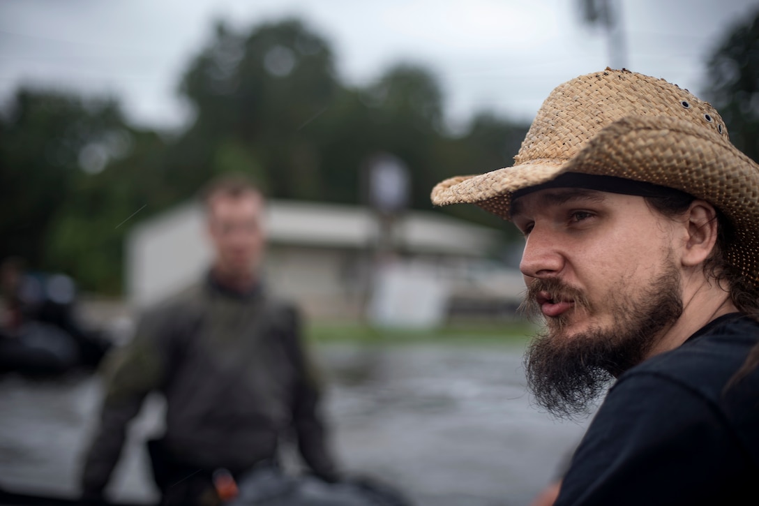 Pararescuemen from the 58th Rescue Squadron speak with a victim of Hurricane Harvey, Aug. 30, 2017, in Orange, Texas.