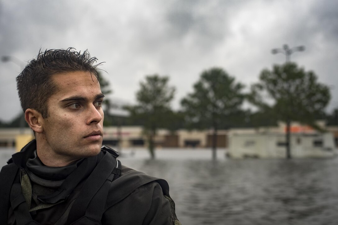 A pararescueman from the 58th Rescue Squadron surveys the flood waters from a rescue boat, Aug. 30, 2017, in Orange, Texas.