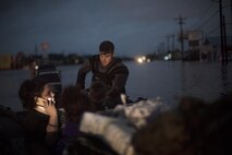 A pararescueman from the 58th Rescue Squadron sits in a rescue boat with a family that was displaced by floodwaters, Aug. 30, 2017, in Orange, Texas. The 347th and 563d Rescue Groups from Moody Air Force Base, Ga., Nellis AFB, Nev., and Davis Montana AFB, Ariz., sent rescue boat teams to Orange County, Texas, and the surrounding areas in support of FEMA during Hurricane Harvey disaster response efforts. (U.S. Air Force photo by Staff Sgt. Ryan Callaghan)
