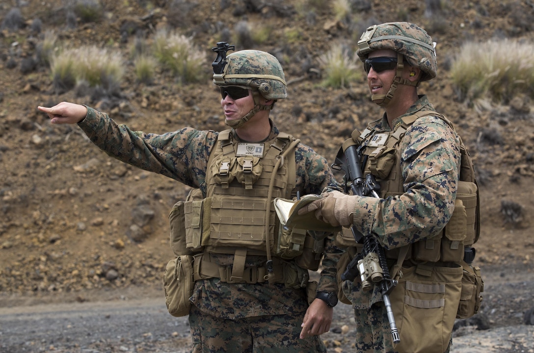 POHAKULOA TRAINING AREA -- Capt. Evan Ota, the operations officer of 3rd Battalion, 3rd Marine Regiment, meets with Capt. Stephen Kent, the company commander of India Company, 3rd Battalion, 3rd Marine Regiment during a platoon live-fire event at Pohakuloa Training Area, Aug. 24, 2017. Ota has overseen the restructuring of this iteration of Bougainville II to include battalion level training events. Exercise Bougainville II prepares 3rd Battalion, 3rd Marine Regiment for service as a forward deployed force in the Pacific by training them to fight as a ground combat element in a Marine Air-Ground Task Force. (U.S. Marine Corps photo by Lance Cpl. Luke Kuennen)