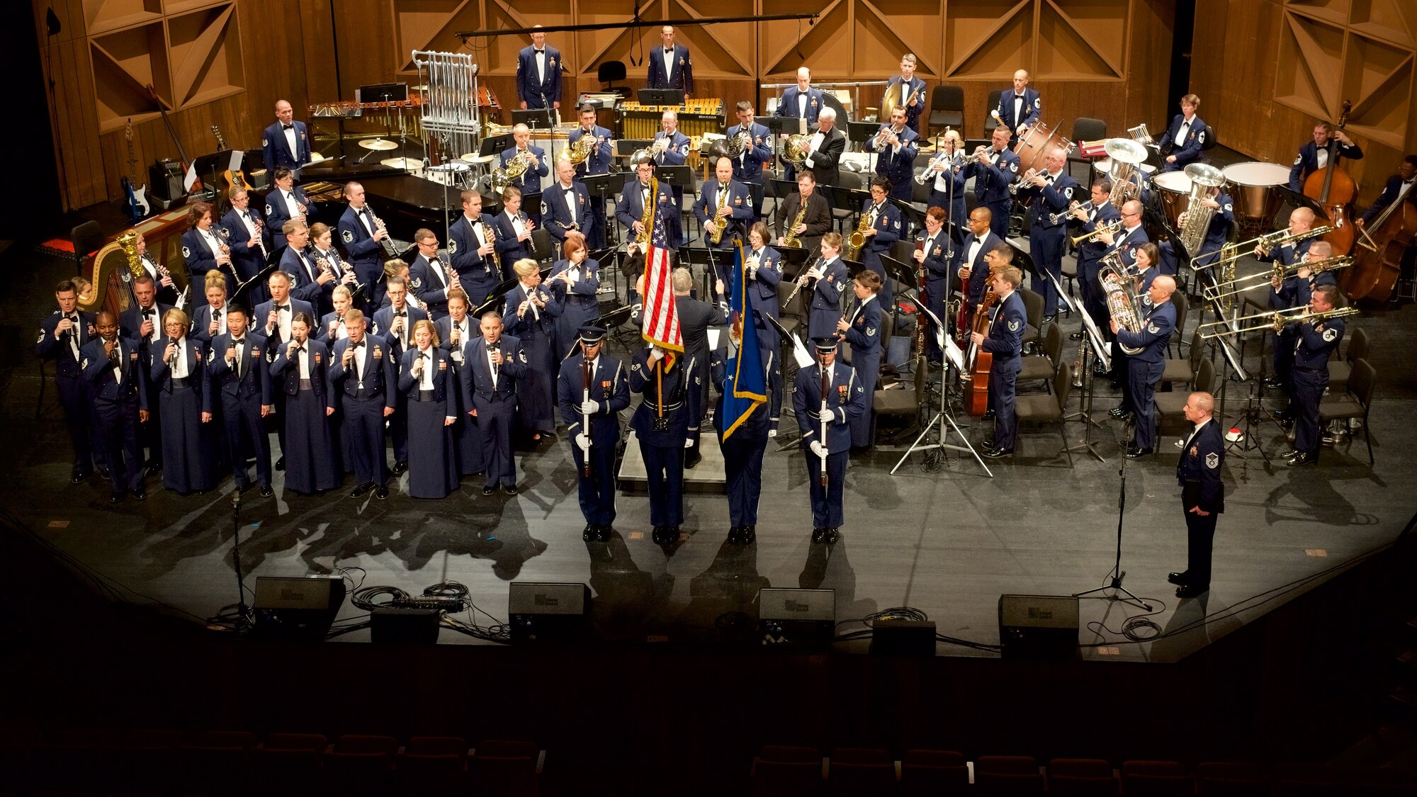 The Concert Band and Singing Sergeants perform the National Anthem with the USAF Honor Guard while on tour in October, 2016. (U.S. Air Force photo/Chief Master Sgt. Bob Kamholz)