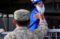 Staff Sgt. Michael Pagaduan, assigned to the Army’s 404th Civil Affairs Battalion, gets a high-five Sept. 1 from ‘Uncle Sam’ prior to a military appreciation game with the United States men's national soccer team at Red Bull Arena in Harrison, New Jersey.  Service members from the Army and Air Force held the U.S. flag for the national anthem.