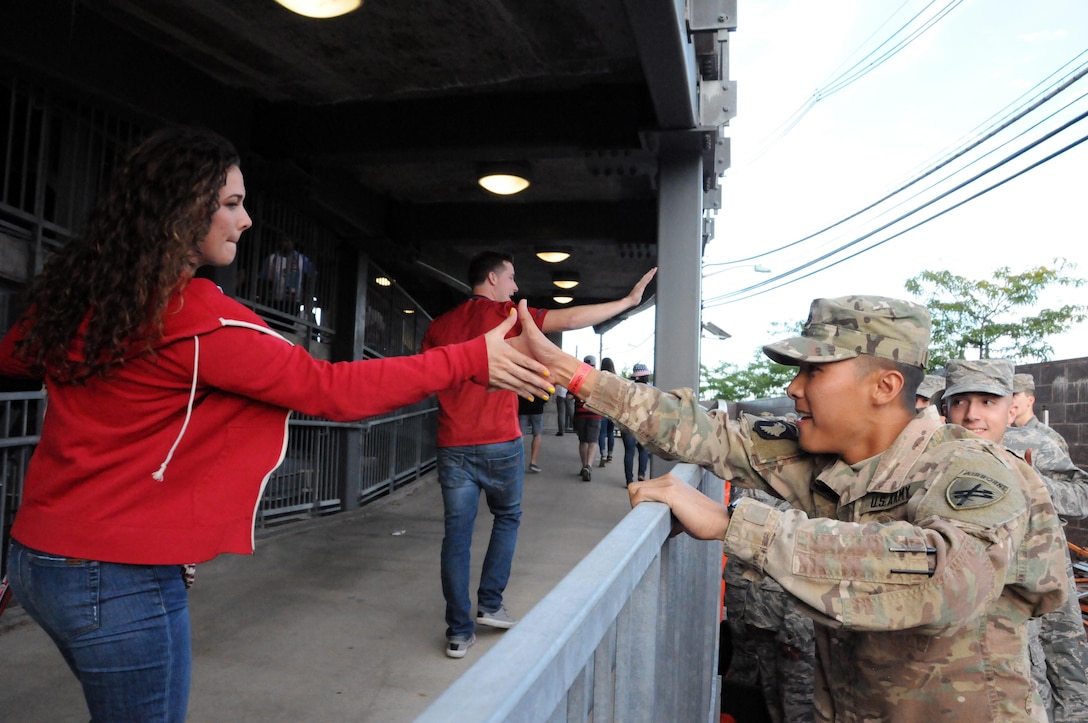 Staff Sgt. Michael Pagaduan, assigned to the Army’s 404th Civil Affairs Battalion, gets a high-five Sept. 1 prior to a military appreciation game with the United States men's national soccer team at Red Bull Arena in Harrison, New Jersey.  Service members from the Army and Air Force held the U.S. flag for the national anthem.