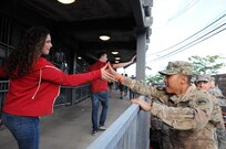 Staff Sgt. Michael Pagaduan, assigned to the Army’s 404th Civil Affairs Battalion, gets a high-five Sept. 1 prior to a military appreciation game with the United States men's national soccer team at Red Bull Arena in Harrison, New Jersey.  Service members from the Army and Air Force held the U.S. flag for the national anthem.