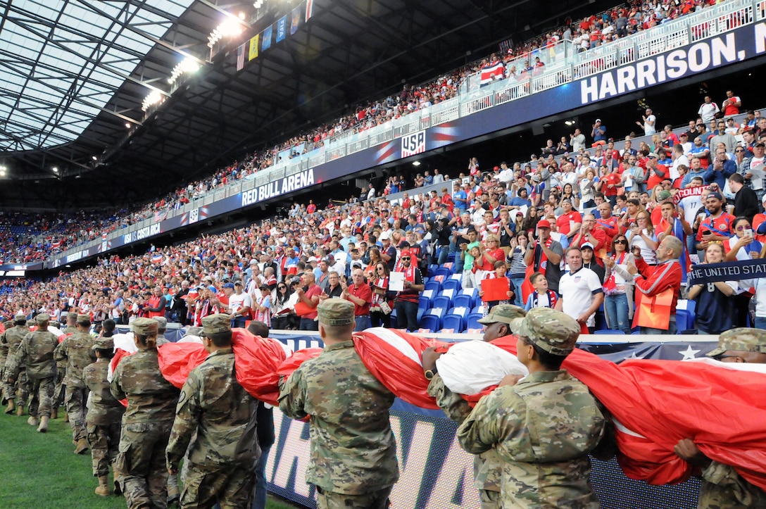 Service members from the Army and Air Force walk into Red Bull Arena Sept. 1 prior to a U.S. Men’s Soccer game.  The service members were there to hold the U.S. flag for the national anthem as part of a military appreciation theme for the game.