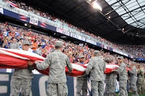 Service members from the Army and Air Force walk into Red Bull Arena Sept. 1 prior to a United States men's national soccer team game.  The service members were there to hold the U.S. flag for the national anthem as part of a military appreciation theme for the game.