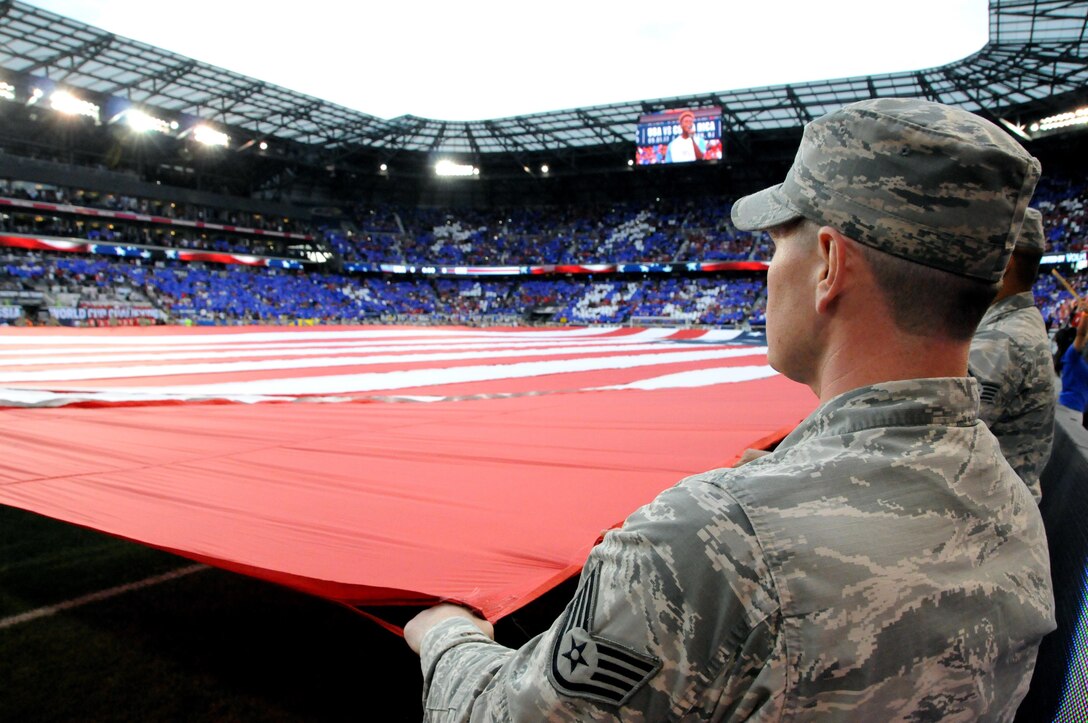 An Air Force Staff Sgt. helps hold the U.S. flag Sept. 1 during a U.S. Men’s Soccer game at Red Bull Arena in Harrison, New Jersey.  The service members were there to hold the flag for the national anthem as part of a military appreciation theme for the game.