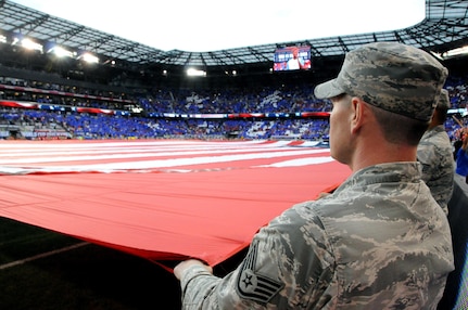 An Air Force Staff Sgt. helps hold the U.S. flag Sept. 1 during a U.S. Men’s Soccer game at Red Bull Arena in Harrison, New Jersey.  The service members were there to hold the flag for the national anthem as part of a military appreciation theme for the game.