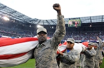Airmen 1st Class Ezell Jones Jr., assigned to the U.S. Air Force’s 305th Maintenance Squadron, reacts to the crowd Sept. 1 after helping to hold the U.S. flag for the national anthem.  The service members were there to hold the flag for the national anthem as part of a military appreciation theme for the game.