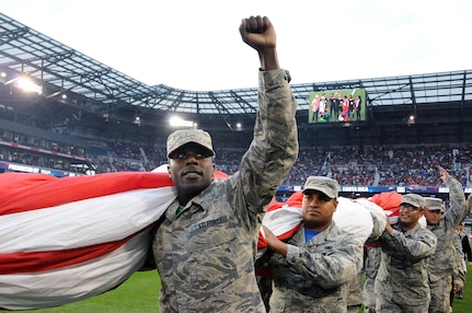 Airmen 1st Class Ezell Jones Jr., assigned to the U.S. Air Force’s 305th Maintenance Squadron, reacts to the crowd Sept. 1 after helping to hold the U.S. flag for the national anthem.  The service members were there to hold the flag for the national anthem as part of a military appreciation theme for the game.