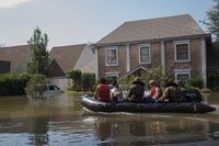 A Marine with Charlie Company, 4th Reconnaissance Battalion, 4th Marine Division, Marine Forces Reserve, along with a member of the Texas Highway Patrol and Texas State Guard, escort a couple to higher ground, Houston, Texas, Aug. 31, 2017. Hurricane Harvey landed Aug. 25, 2017, flooding thousands of homes and displaced over 30,000 people.