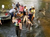 Hospital corpsman, Petty Officer 1st Class Komi Gayakpa (left) and assault amphibian vehicle Marines, Lance Cpl. Arturo Platamartinez (center) and Lance Cpl. Alejandro Lopez (right), with 4th Assault Amphibian Battalion, 4th Marine Division, Marine Forces Reserve, perform search and rescue operations in Lumberton, Texas, Aug. 31, 2017.  Marines with C Company rescued over 300 locals on Aug. 31, 2017, as part of the response effort in support of FEMA and other local and government and state agencies after Hurricane Harvey.