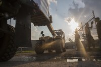 A Marine Corps Kalmar RT-022 from 14th Marine Regiment, 4th Marine Division, Marine Forces Reserve, removes a pallet of supplies form a Marine Corps 7-ton Truck outside a Red Cross warehouse in Beaumont, Texas, Sept. 2, 2017. 14th Marines, based out of Fort Worth, Texas, traveled to Beaumont to transport supplies to locals affected by Hurricane Harvey which devastated areas of eastern Texas.