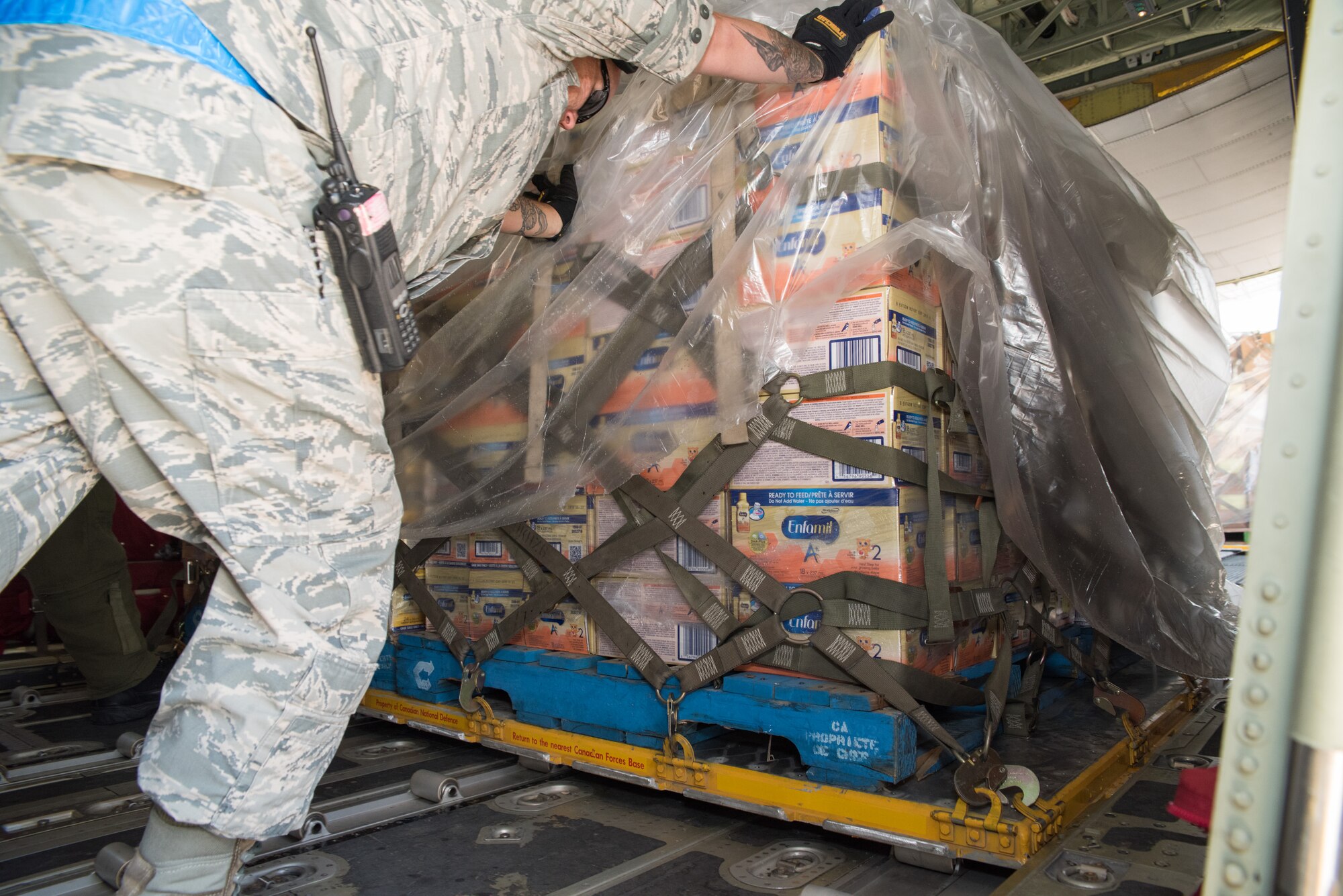 Members with 502nd Logistics Readiness Squadron and U.S. Army Soldiers unload a Royal Canadian Air Force CC-130J Hercules at Joint Base San Antonio-Lackland Kelly Field, Texas carrying humanitarian supplies from the government of Canada to aid in Hurricane Harvey relief efforts Sept. 3, 2017. The supplies included pediatric necessities like baby formula, blankets, cribs and other similar items. The RCAF airlift flew in from 8 Wing Trenton, Ontario, Canada.