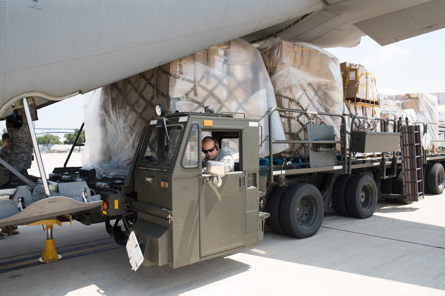 Members with 502nd Logistics Readiness Squadron and U.S. Army Soldiers unload a Royal Canadian Air Force CC-130J Hercules at Joint Base San Antonio-Lackland Kelly Field, Texas carrying humanitarian supplies from the government of Canada to aid in Hurricane Harvey relief efforts Sept. 3, 2017. The supplies included pediatric necessities like baby formula, blankets, cribs and other similar items. The RCAF airlift flew in from 8 Wing Trenton, Ontario, Canada.