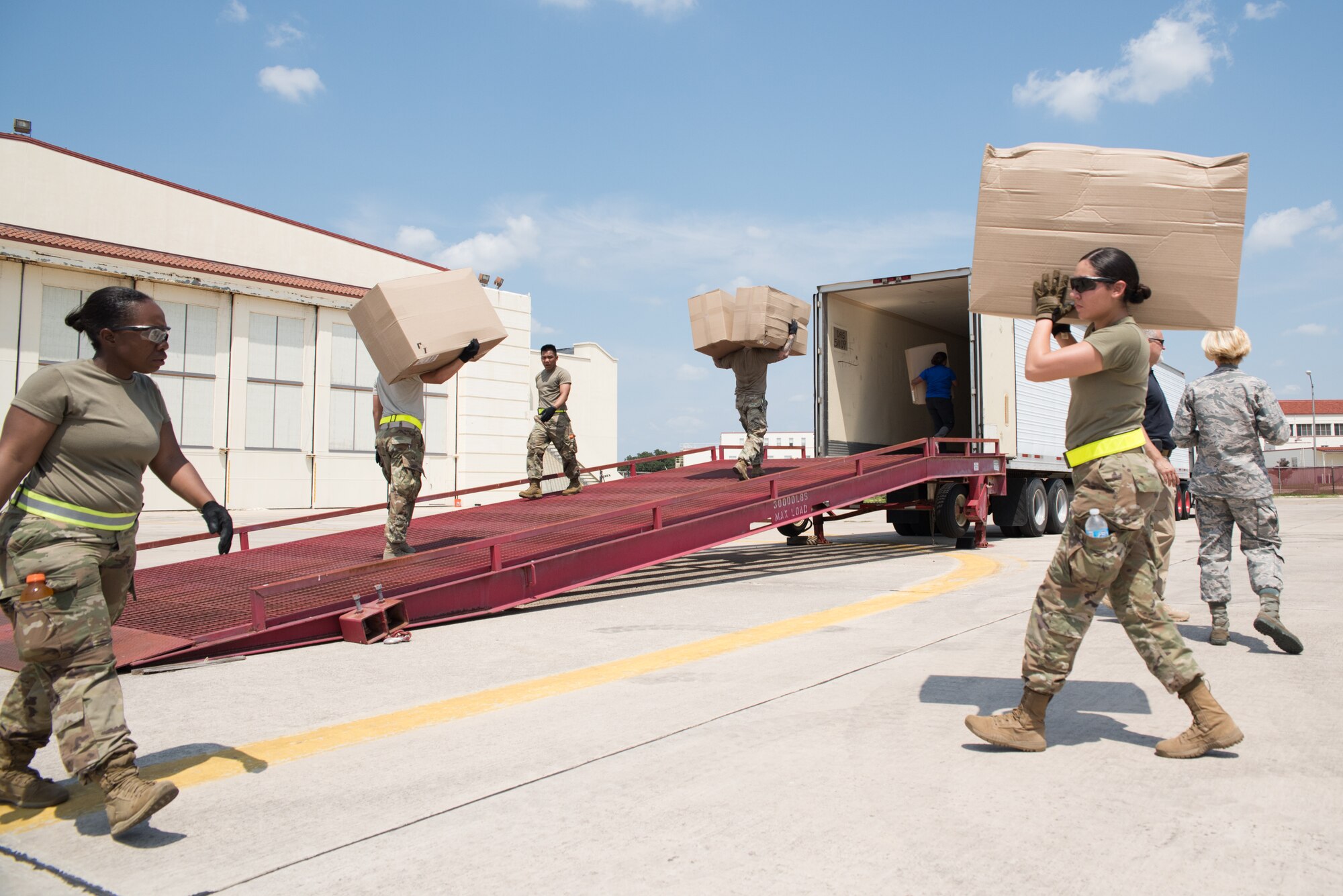 Members with 502nd Logistics Readiness Squadron and U.S. Army Soldiers unload a Royal Canadian Air Force CC-130J Hercules at Joint Base San Antonio-Lackland Kelly Field, Texas carrying humanitarian supplies from the government of Canada to aid in Hurricane Harvey relief efforts Sept. 3, 2017. The supplies included pediatric necessities like baby formula, blankets, cribs and other similar items. The RCAF airlift flew in from 8 Wing Trenton, Ontario, Canada.