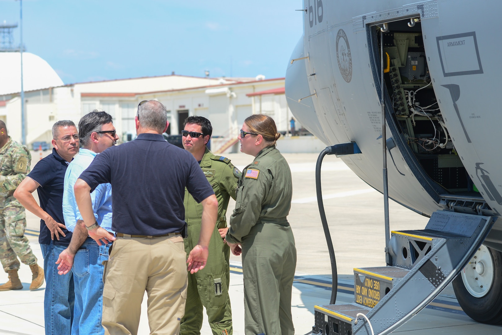 Mr. Vasken Khabayan (second from left), Acting Consul General of Canada in Dallas, greets the Royal Canadian aircrew pilot Capt. Daniel Ebisuzaki (second from right) and U.S. Air Force pilot Maj. Kimberley Sercel (right) of a CC-130J Hercules at Joint Base San Antonio-Lackland Kelly Field, Texas carrying humanitarian supplies from the government of Canada to aid in Hurricane Harvey relief efforts Sept. 3, 2017. The supplies included pediatric necessities like baby formula, blankets, cribs and other similar items. The RCAF airlift flew in from 8 Wing Trenton, Ontario, Canada.