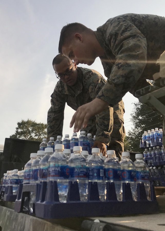 BEAUMONT, TX - U.S. Marines from 14th Marine Regiment, 4th Marine Division, Marine Forces Reserve, unload pallets of water from an MTVR 7-ton truck at Rosehill Acres, Texas, Sept. 3, 2017.  14th Marines, based out of Ft. Worth, Texas, is participating in relief efforts for those effected by Hurricane Harvey. (U.S. Marine Corps photo by Master Sgt. Ricardo Morales/Released)