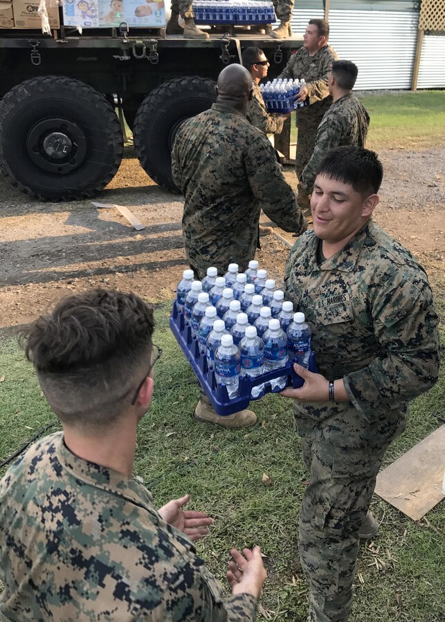 BEAUMONT, TX - U.S. Marines from 14th Marine Regiment, 4th Marine Division, Marine Forces Reserve, unload pallets of water from an MTVR 7-ton truck at Rosehill Acres, Texas, Sept. 3, 2017.  14th Marines, based out of Ft. Worth, Texas, is participating in relief efforts for those effected by Hurricane Harvey. (U.S. Marine Corps photo by Master Sgt. Ricardo Morales/Released)