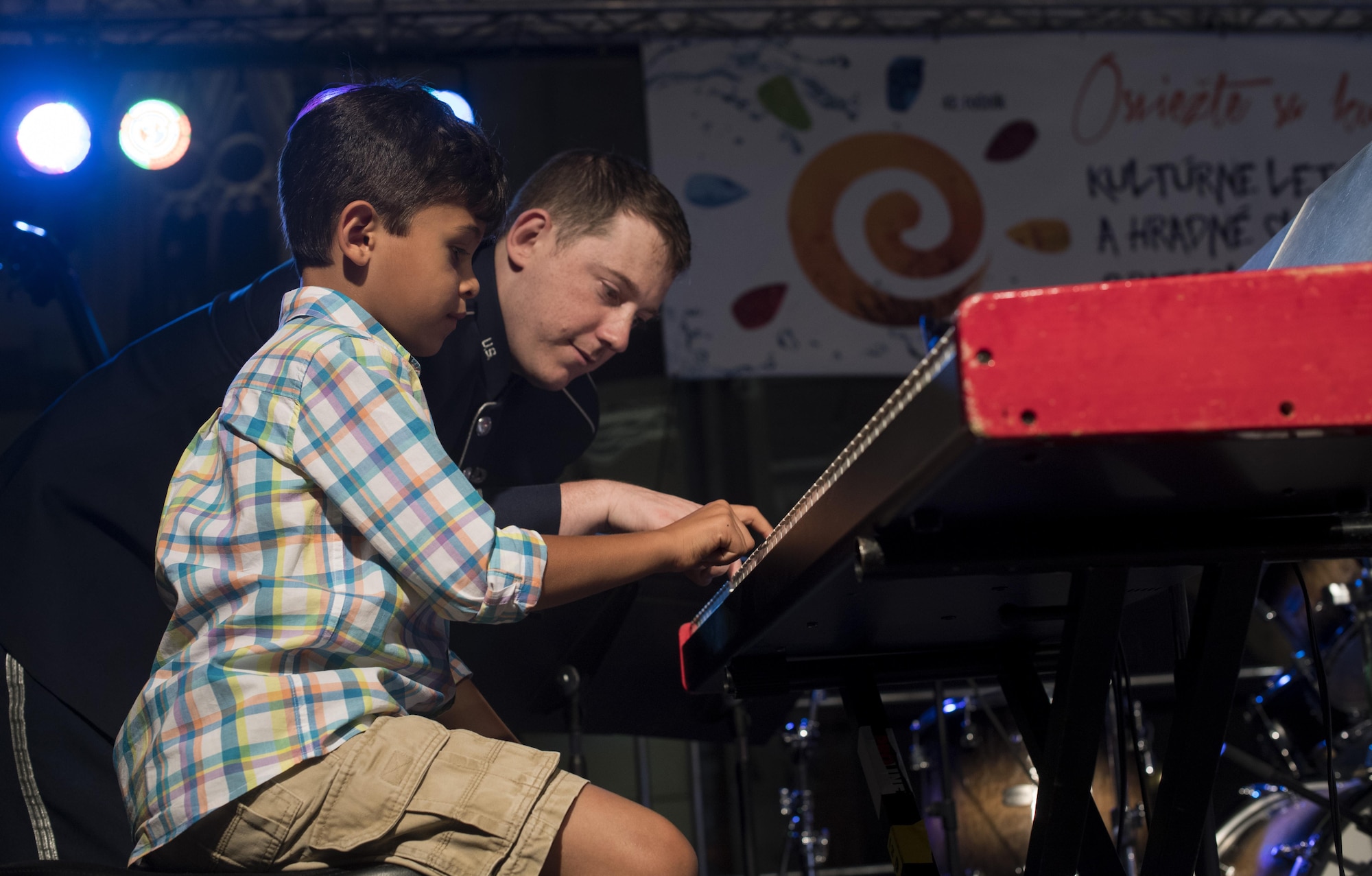 U.S. Air Force Staff Sgt. Justin Cockerham, U.S. Air Forces in Europe piano, plays “Ode to Joy” with a child after performing for the 73rd anniversary of the Slovak National Uprising in Bratislava, Slovakia, Aug. 30, 2017. The USAFE band serves to increase cultural ties and to enhance the people-to-people relationship between the U.S. and Slovakia. (U.S. Air Force photo by Senior Airman Tryphena Mayhugh
