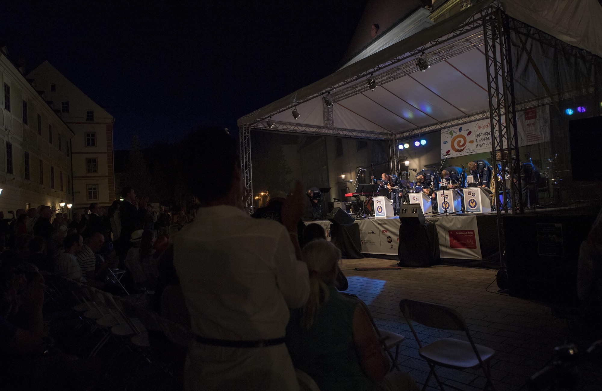 Members of The Ambassadors, U.S. Air Forces in Europe jazz band, take a bow after performing a concert for the 73rd anniversary of the Slovak National Uprising in Bratislava, Slovakia, Aug. 30, 2017. The jazz band, known as the Ambassadors, was comprised of 13 Airmen for this performance, to include saxophones, trombones, trumpets, percussion, and bass players. The USAFE band represents unique international musical heritage, building and preserving partnerships through official multi-national military and international community outreach events. (U.S. Air Force photo by Senior Airman Tryphena Mayhugh)