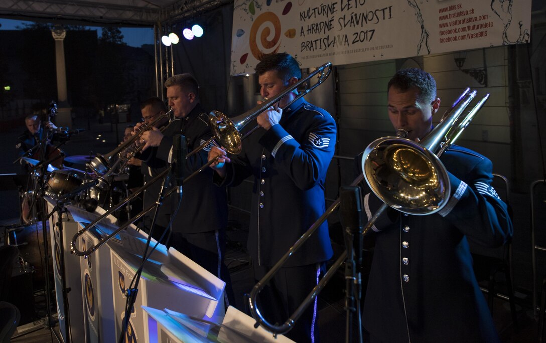 Trombone and trumpet players in the U.S. Air Forces in Europe jazz band play their instruments during a concert for the 73rd anniversary of the Slovak National Uprising in Bratislava, Slovakia, Aug. 30, 2017. U.S. bands are invited each year to perform for the celebration. Participating in events with NATO allies improves interoperability and strengthens long standing relationships. (U.S. Air Force photo by Senior Airman Tryphena Mayhugh)