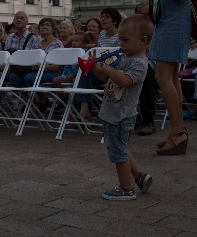 A child plays a toy trumpet along with the U.S. Air Forces in Europe jazz band as they perform a concert for the 73rd anniversary of the Slovak National Uprising in Bratislava, Slovakia, Aug. 30, 2017. The USAFE band represents unique international musical heritage, building and preserving partnerships through official multi-national military and international community outreach events. (U.S. Air Force photo by Senior Airman Tryphena Mayhugh)