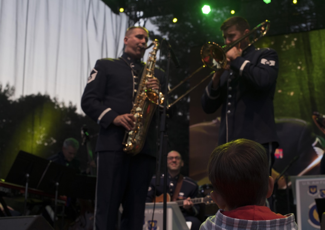 A child listens to the Ambassadors, the U.S. Air Forces in Europe jazz band, as they perform for the 73rd anniversary of the Slovak National Uprising in Banská Bystrica, Slovakia, Aug. 29, 2017. The band played at the Museum of Slovak National Uprising for the event. The USAFE band represents unique international musical heritage, building and preserving partnerships through official multi-national military and international community outreach events. (U.S. Air Force photo by Senior Airman Tryphena Mayhugh)