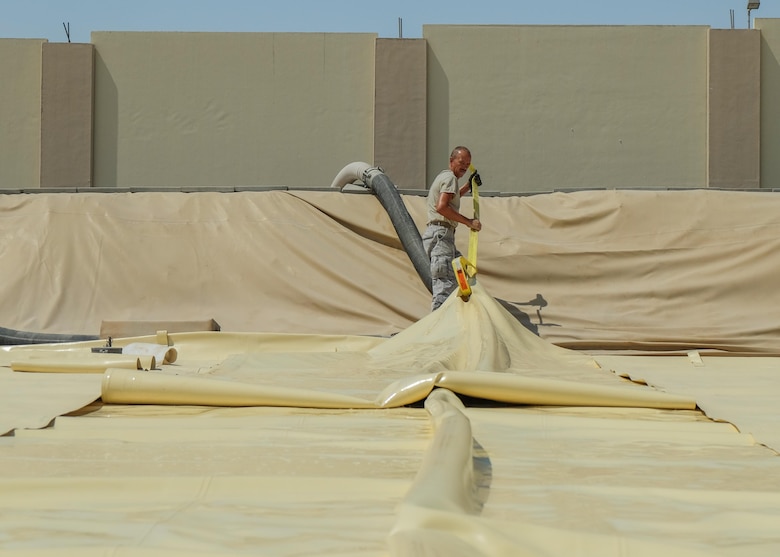 Master Sgt. Eric Henderson, 380th Expeditionary Logistics Readiness Squadron fuels management technician, removes a strip from a fuel bladder Aug. 4, 2017, at Al Dhafra Air Base, United Arab Emirates.