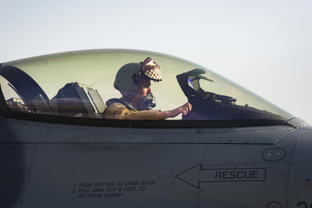 An Air Force pilot prepares to exit an F-16 Fighting Falcon