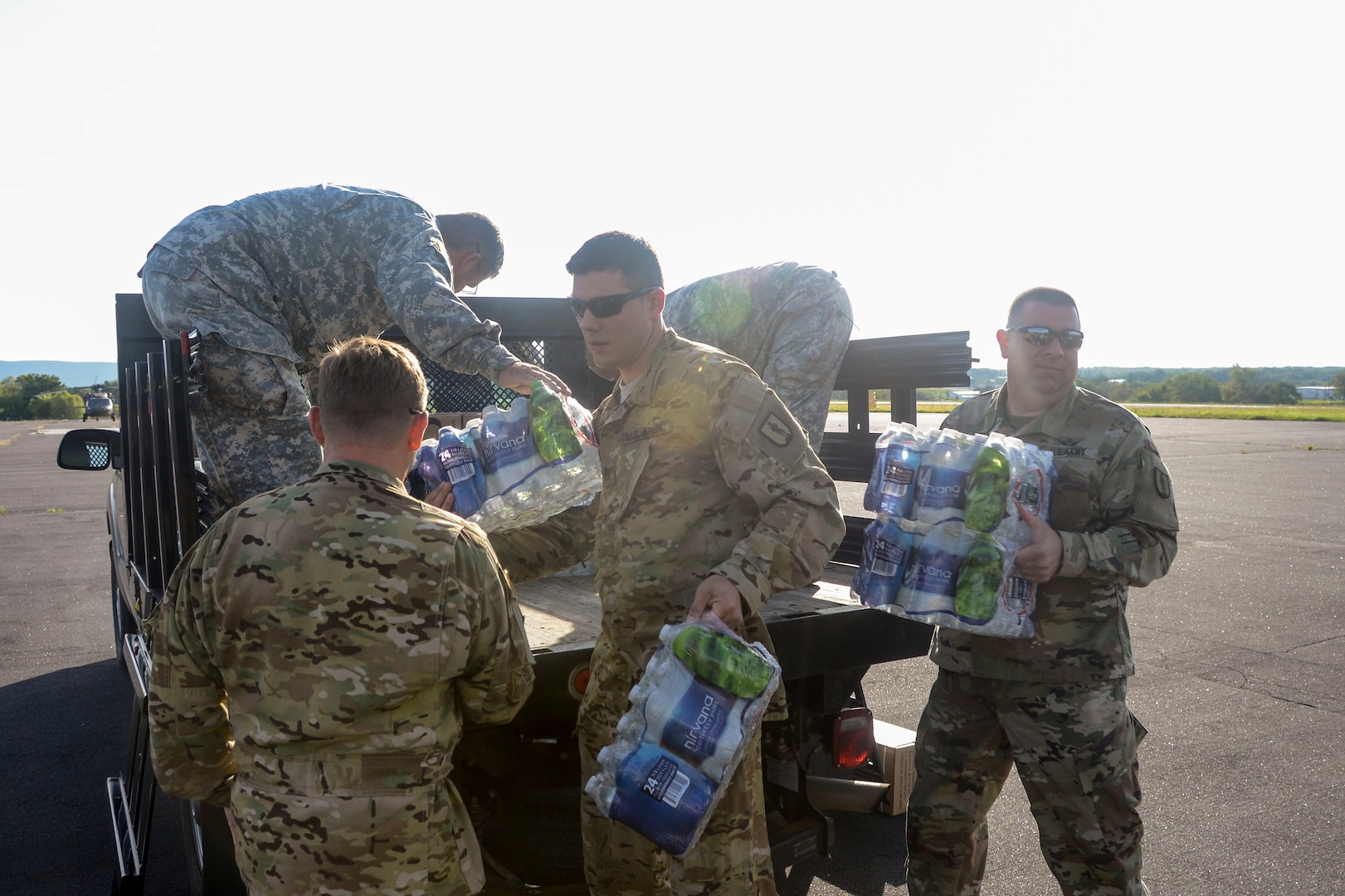 Soldiers load bottled water onto a CH-47 Chinook