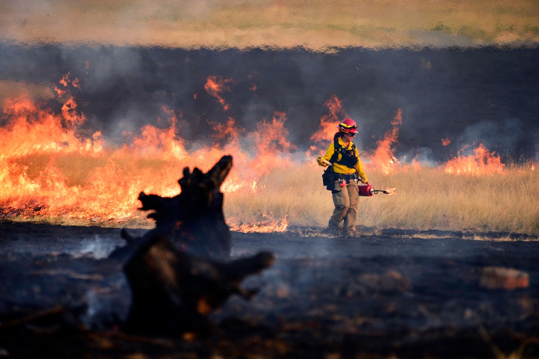 Julie Olsen-Fink, a training instructor from the Oregon Department of Public Safety Standards, initiates a controlled burn