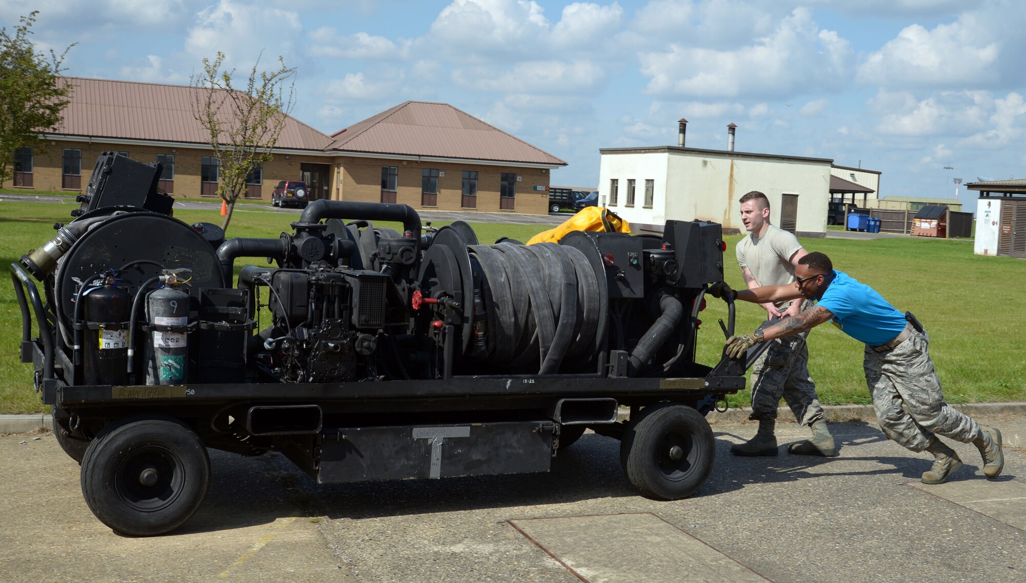 Airmen push cart during foot race