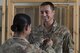 Sgt. Maj. Janet Blunt, U.S. Army Central Forward Command Post G-4 Sgt. Maj. of logistics, places the rank of technical sergeant on her son Jason Blunt, 557th RED HORSE craft lead, Sep. 1, 2017, in Southwest Asia. Both are currently deployed to separate undisclosed locations, but through some coordination Blunt was able surprise her son by attending his promotion ceremony. (U.S. Air Force photo/Senior Airman Damon Kasberg)