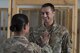 Sgt. Maj. Janet Blunt, U.S. Army Central Forward Command Post G-4 Sgt. Maj. of logistics, places the rank of technical sergeant on her son Jason Blunt, 557th RED HORSE craft lead, Sep. 1, 2017, in Southwest Asia. Both are currently deployed to separate undisclosed locations, but through some coordination Blunt was able surprise her son by attending his promotion ceremony. (U.S. Air Force photo/Senior Airman Damon Kasberg)
