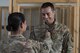 Sgt. Maj. Janet Blunt, U.S. Army Central Forward Command Post G-4 Sgt. Maj. of logistics, places the rank of technical sergeant on her son Jason Blunt, 557th RED HORSE craft lead, Sep. 1, 2017, in Southwest Asia. Both are currently deployed to separate undisclosed locations, but through some coordination Blunt was able surprise her son by attending his promotion ceremony. (U.S. Air Force photo/Senior Airman Damon Kasberg)