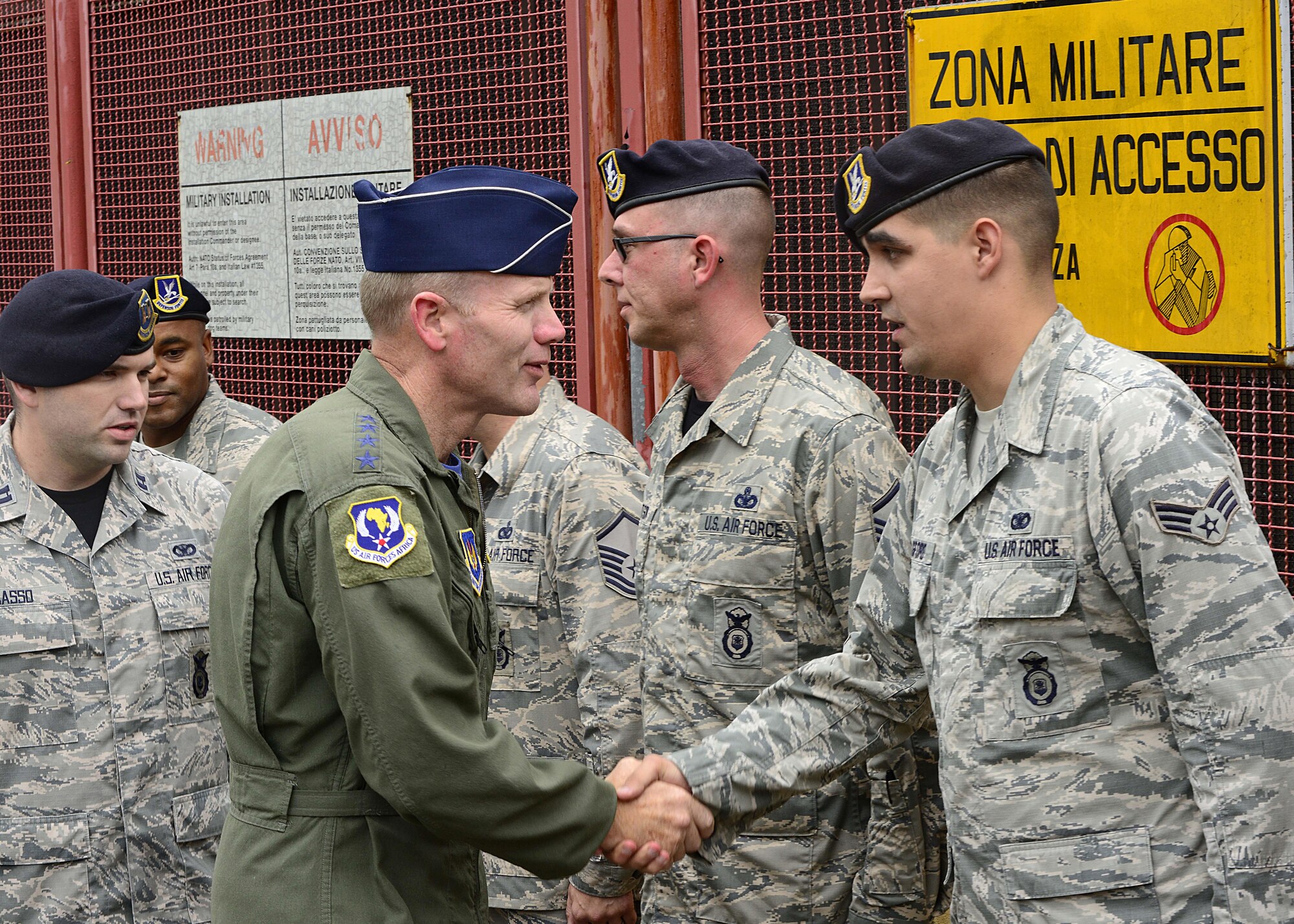 Gen. Tod Wolters, U.S. Air Forces in Europe and Air Forces Africa commander, coins Senior Airman Jeffrey Langford, 31st Security Forces Squadron security response team member, Sept. 1, 2017, at Aviano Air Base, Italy. During his visit he met with many Airmen and toured several base facilities. (U.S. Air Force photo by Airman 1st Class Ryan Brooks)