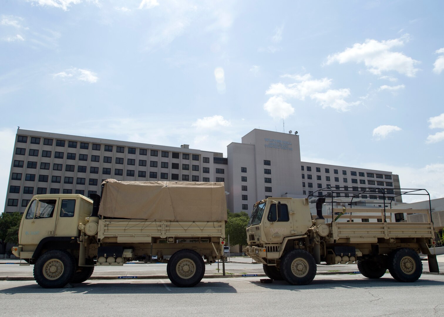 Two light medium tactical vehicle is parked outside of the old Wilford Hall Ambulatory Surgical Center Sept. 2 after dropping off 67 soldiers, on Joint Base San Antonio-Lackland, Texas. More than 500 soldiers are awaiting future deployment instructions at the old Wilford Hall in response to the devastation caused by Hurricane Harvey.