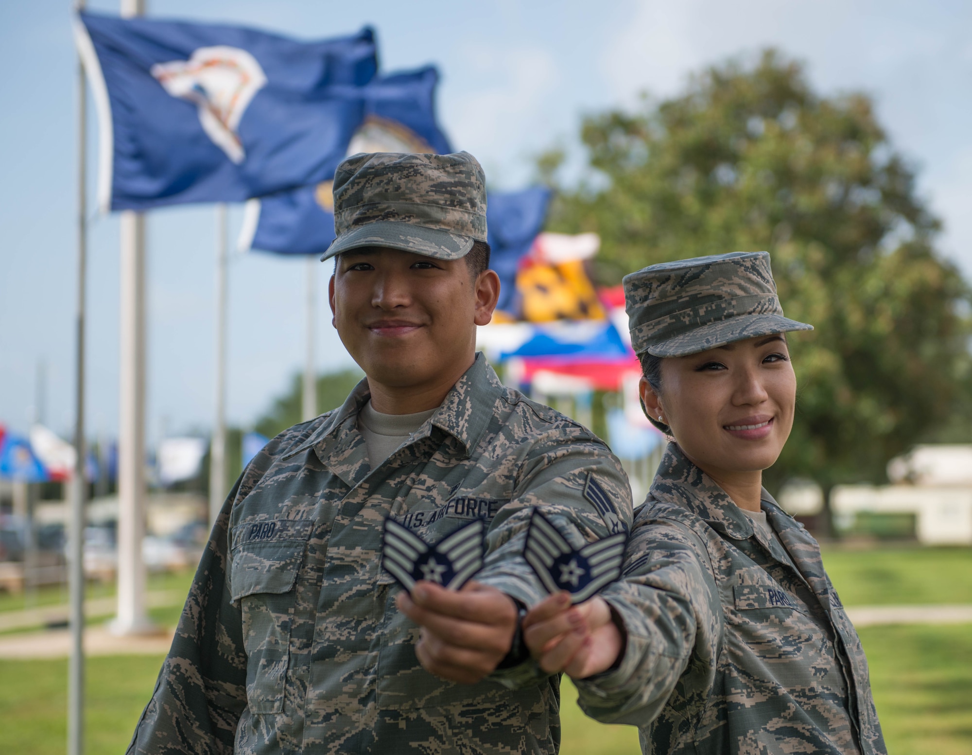 Senior Airmen Anthony and Christina Paro, a husband and wife with the 96th Aerospace Medicine Squadron, smile as they hold their promotion stripes at Eglin AFB, Fla. Aug 30.