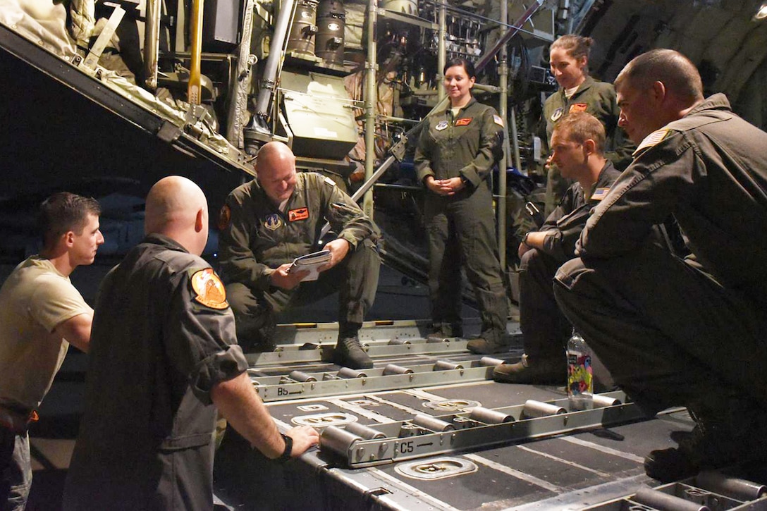 An aircrew is briefed before leaving its home base.