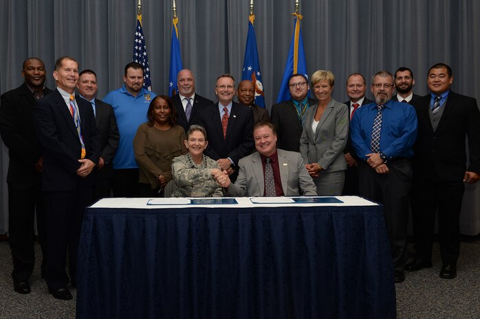 Gen. Ellen M. Pawlikowski, Air Force Materiel Command commander; Troy Tingey, American Federation of Government Employees Council 214 president; and the Master Labor Agreement negotiation teams pose for a group photo after the Master Labor Agreement signing ceremony at Headquarters Air Force Materiel Command Aug. 23, 2017. (U.S. Air Force photo/Michelle Gigante)