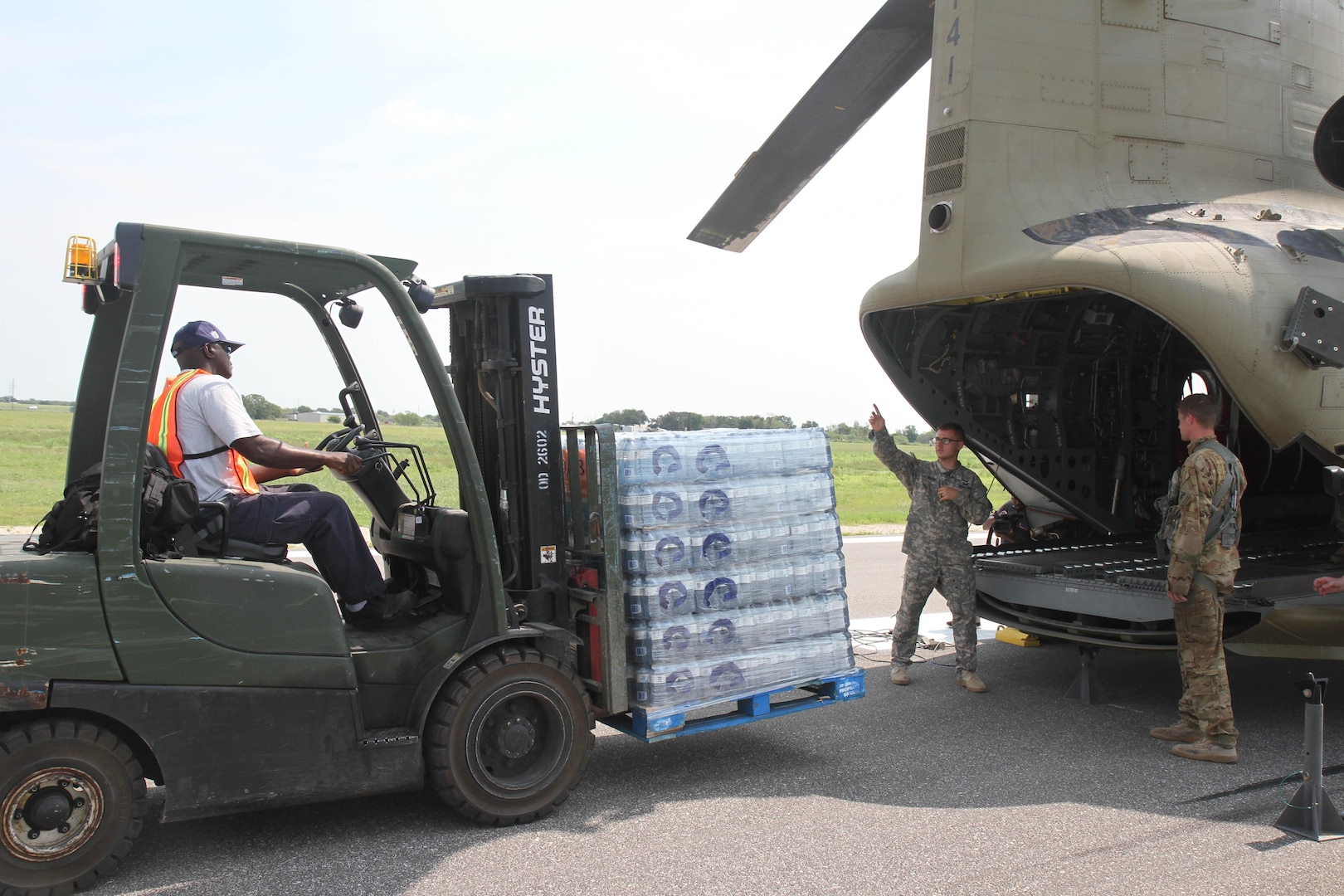 Soldiers with 2nd Battalion, 501st Aviation Regiment from Fort Bliss, Texas, help load pallets of water onto a CH-47 Chinook at Joint Base San Antonio-Seguin Auxiliary Airfield in Seguin, Texas as part Hurricane Harvey Relief efforts Sept. 3. One pallet contained 2,375 pounds of bottled water for citizens affected by Harvey.