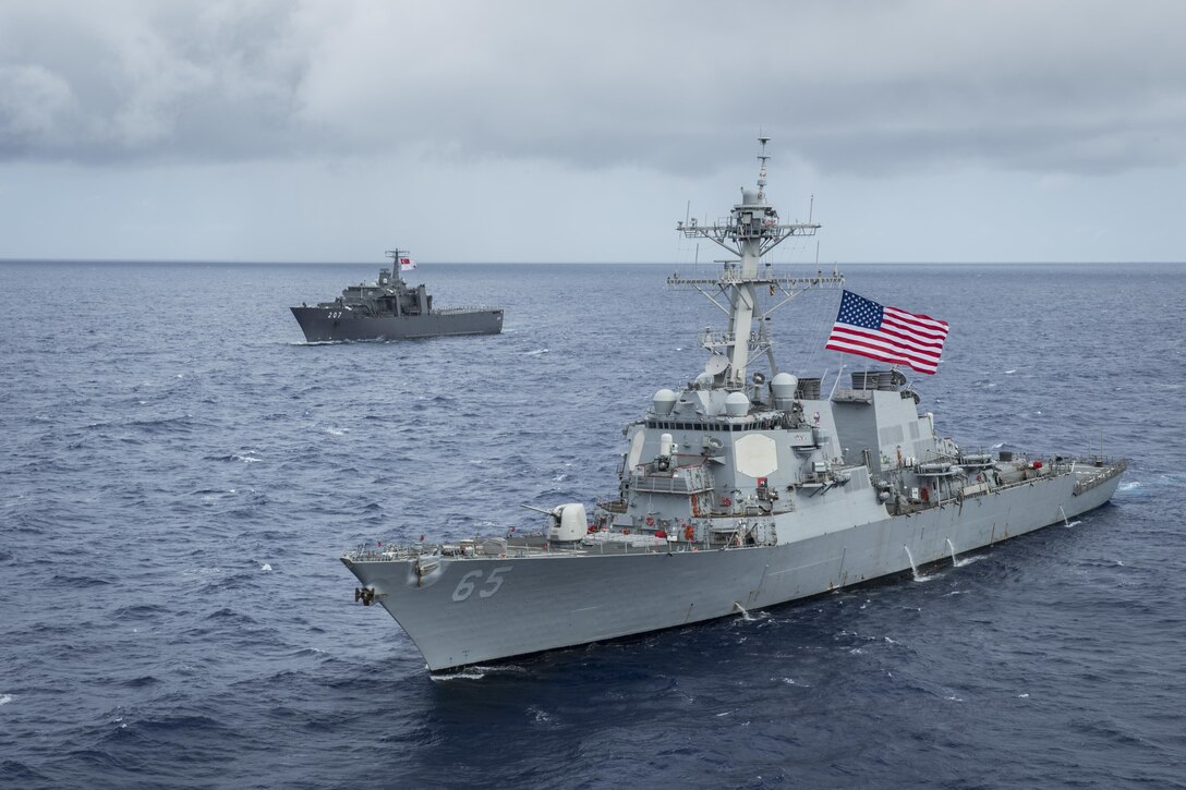 Two military ships take part in an exercise off the coast of Guam.